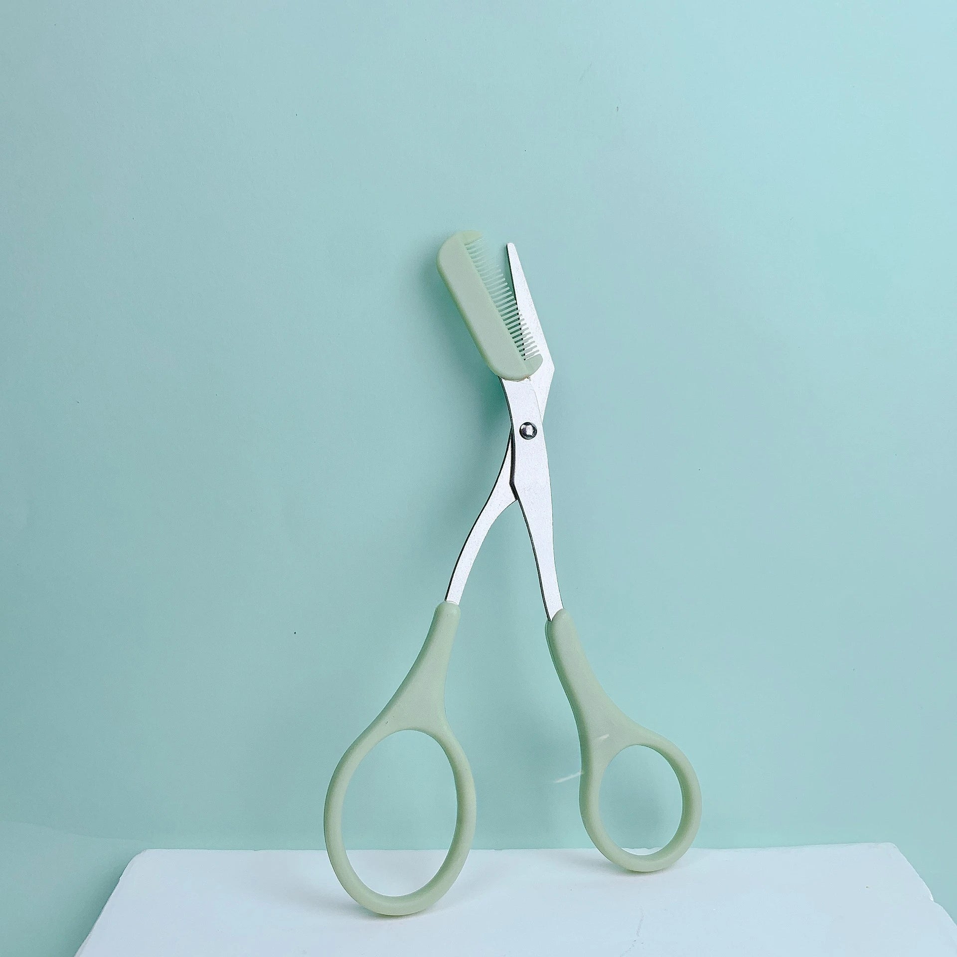Pink eyebrow trimming scissors with built-in comb - stainless steel, precise grooming tool, creating perfect eyebrows